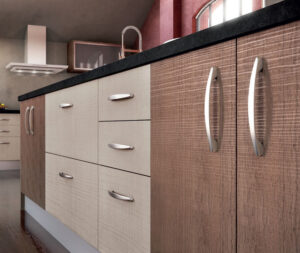 Two-tone textured SYNCRON cabinets in light oak and walnut with curved metal handles.